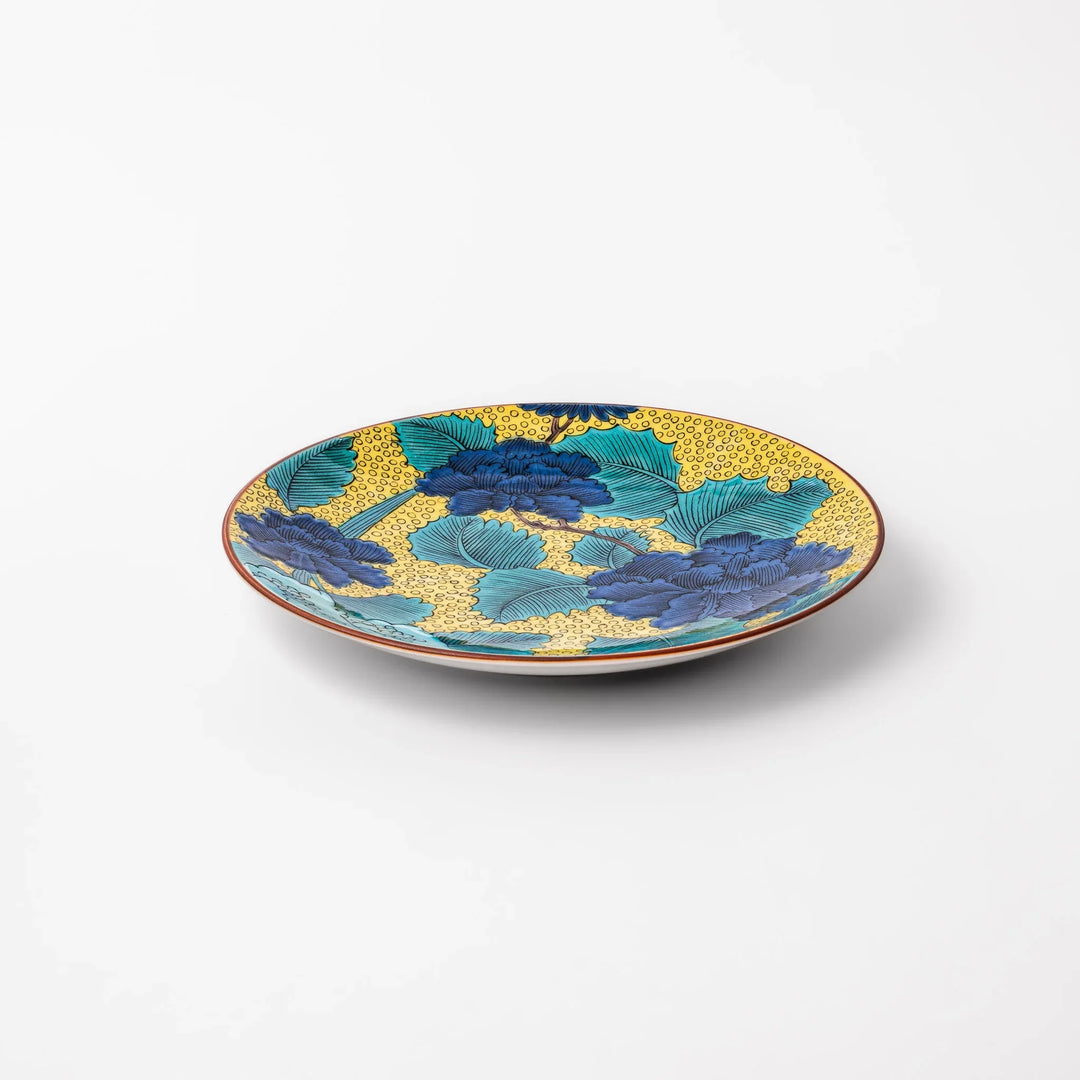 Japanese porcelain dessert plate with blue peony flowers green leaves and golden yellow background.
