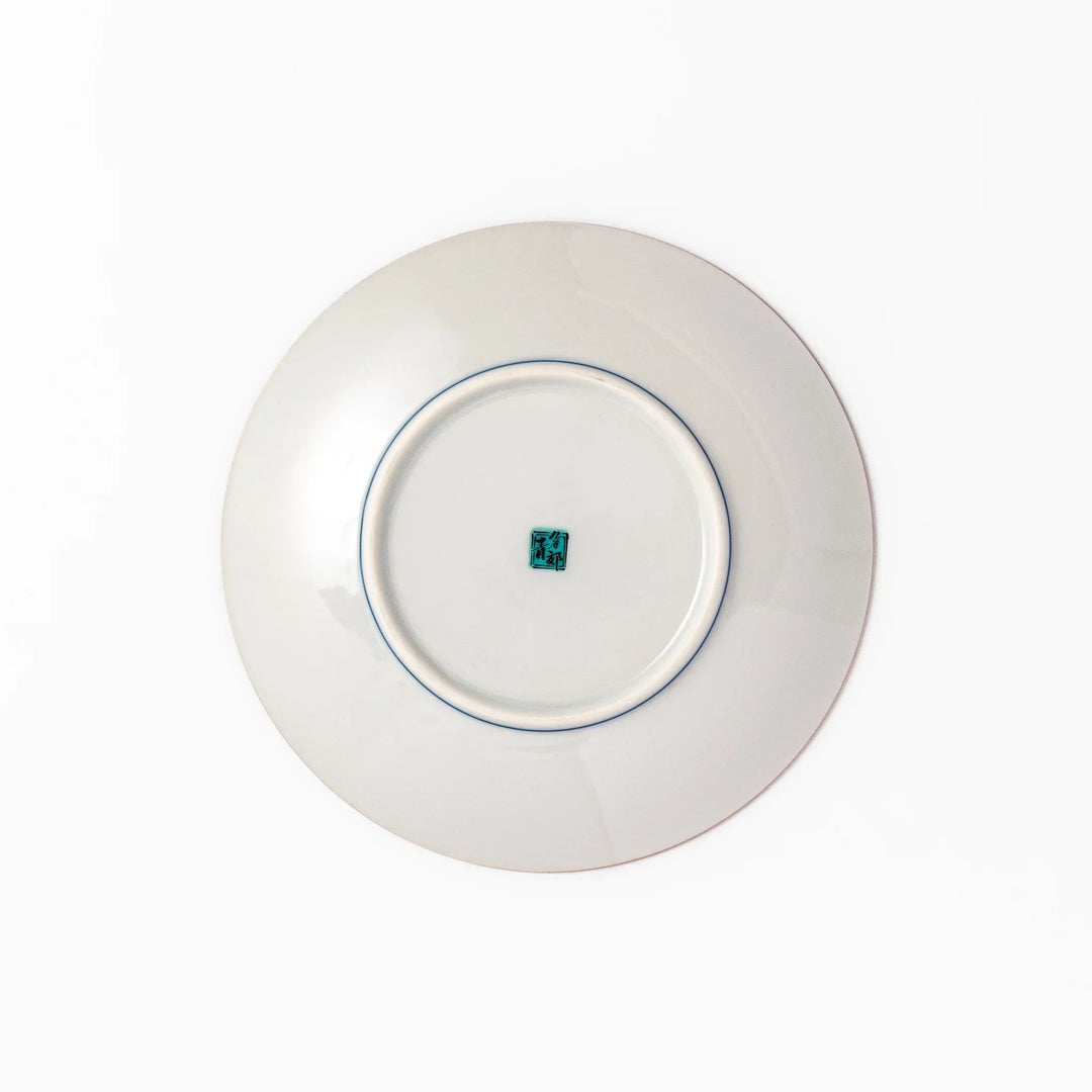 Japanese porcelain dessert plate with blue peony flowers green leaves and golden yellow background.