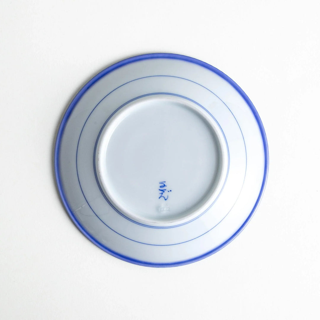 A round white dessert plate with a rustic scallop-edged border. The border comes in blue, brown, and olive.