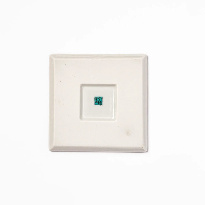 Square blue Japanese ceramic coaster with white sakura blossom and petal design for traditional dining.