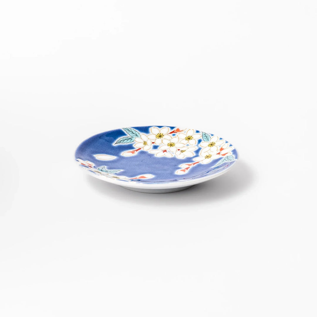 Blue Japanese ceramic sauce dish with white sakura blossom design for serving soy sauce or condiments.