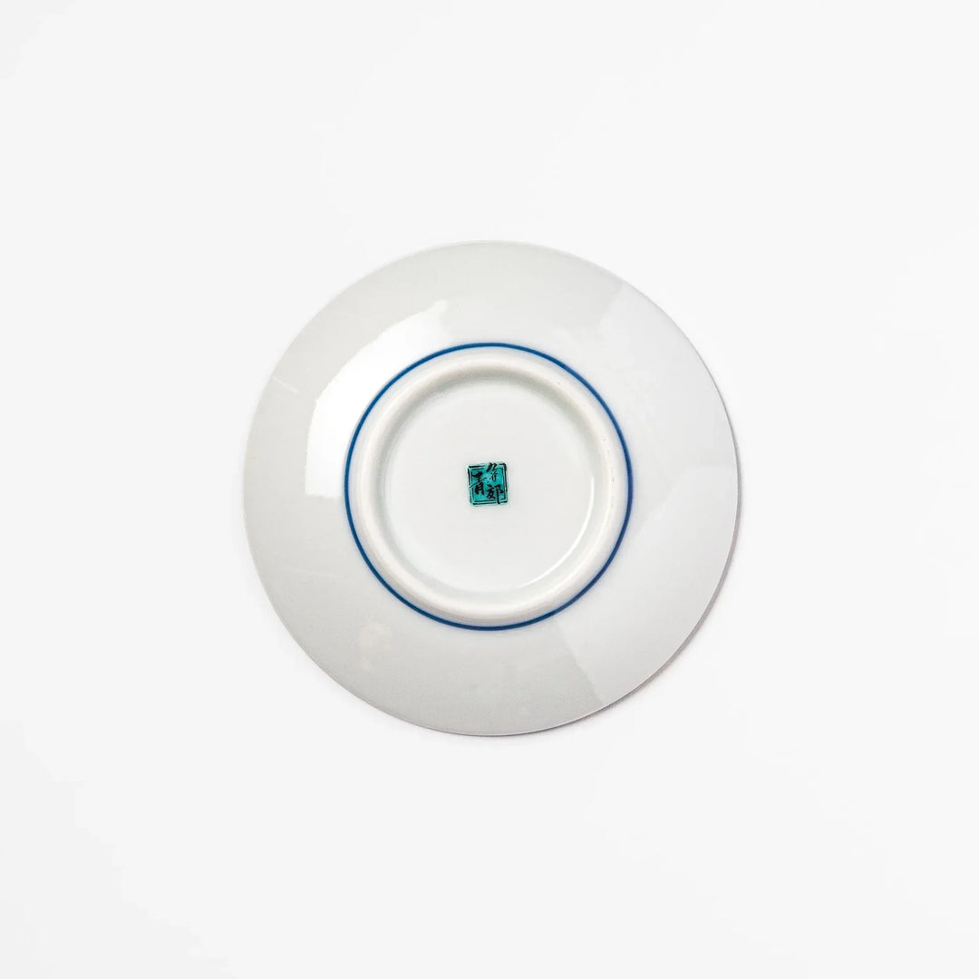 Blue Japanese ceramic sauce dish with white sakura blossom design for serving soy sauce or condiments.