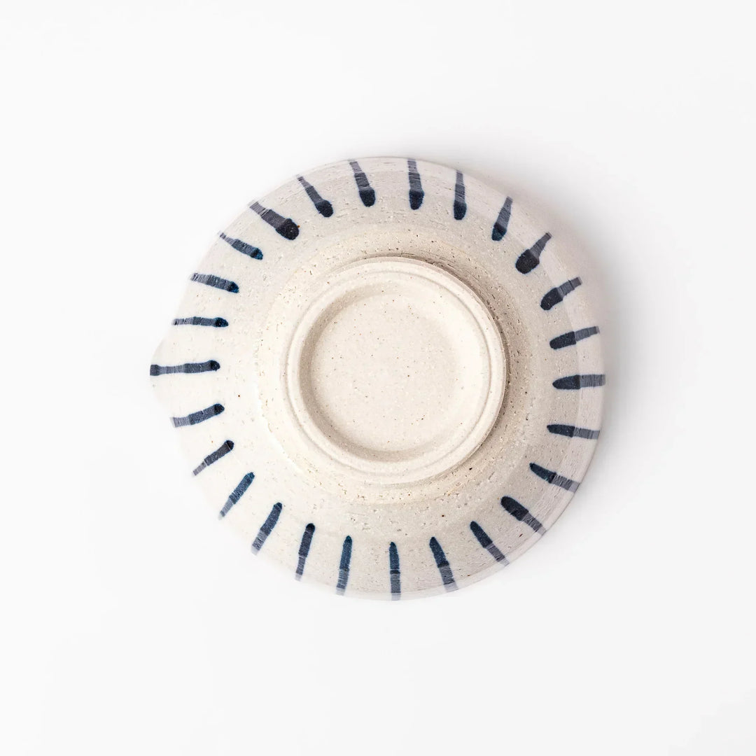 White ceramic suribachi mortar with blue stripes and brown textured interior for grinding sesame seeds.