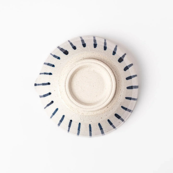 White ceramic suribachi mortar with blue stripes and brown textured interior for grinding sesame seeds.