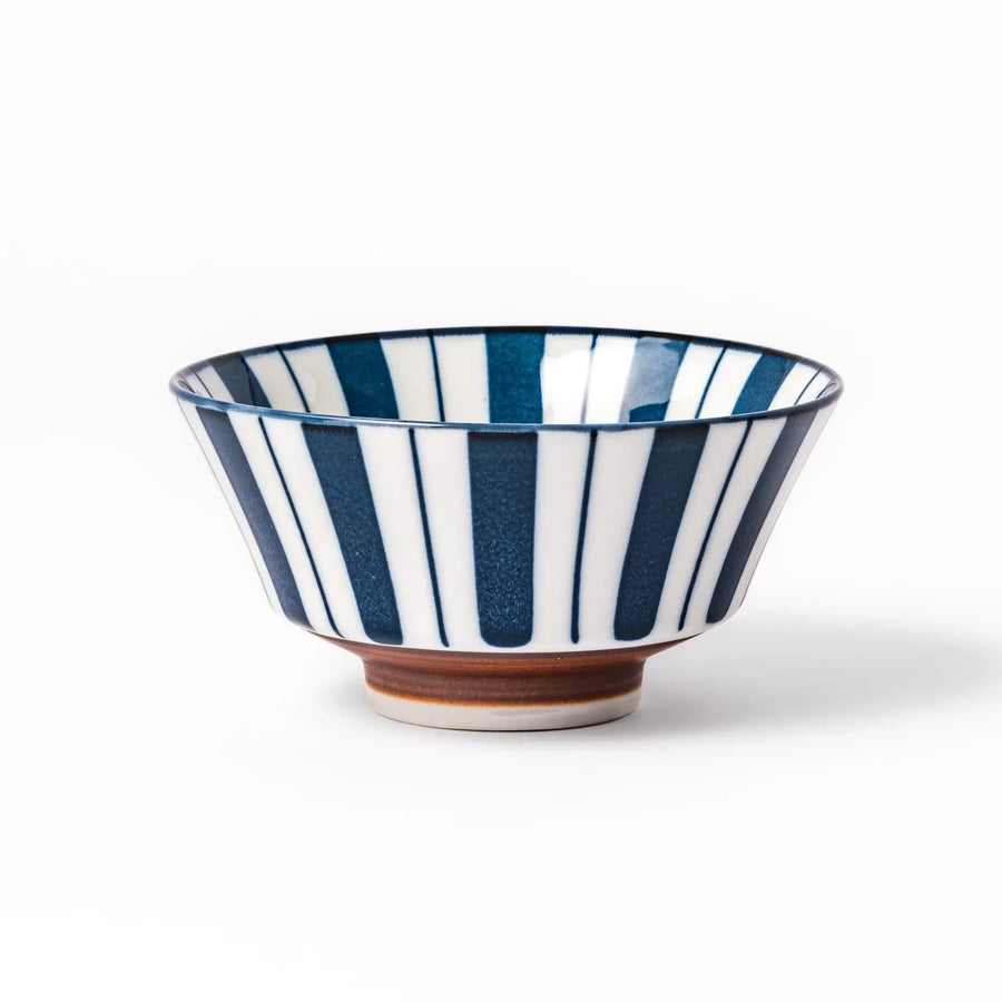 Japanese porcelain rice bowl with bold indigo and white stripes and terracotta base in modern classic style.