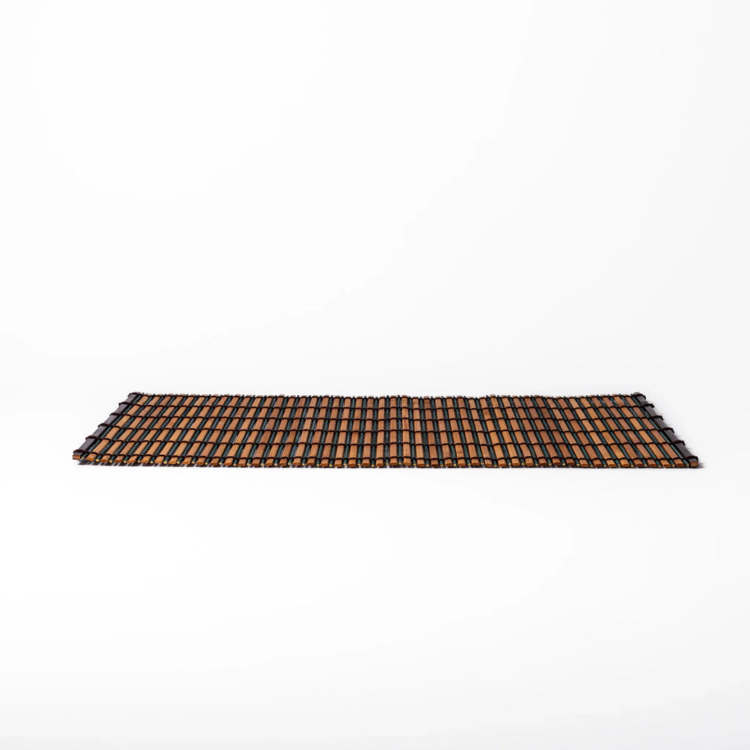 Brown bamboo table mat with dark and natural slats bound with black cord for warm Japanese table settings.