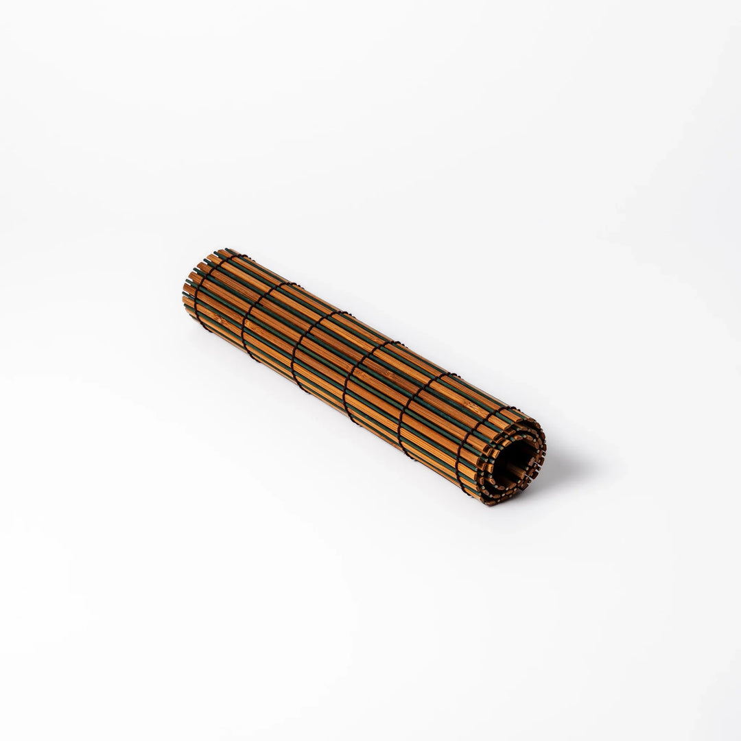 Brown bamboo table mat with dark and natural slats bound with black cord for warm Japanese table settings.