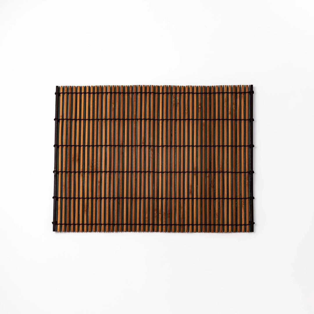 Brown bamboo table mat with dark and natural slats bound with black cord for warm Japanese table settings.