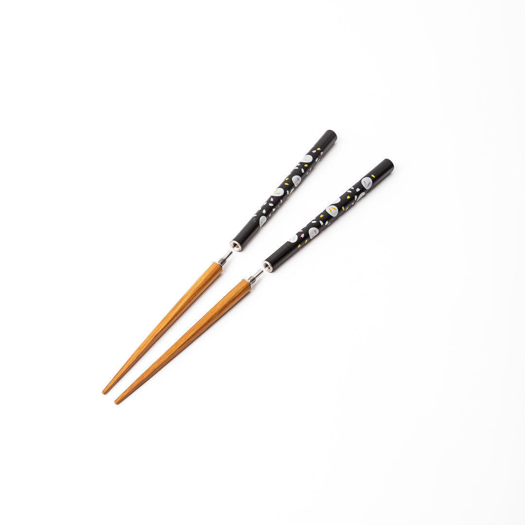 Portable Japanese travel chopsticks detached into two pieces showing the screw in metal joints for easy assembly