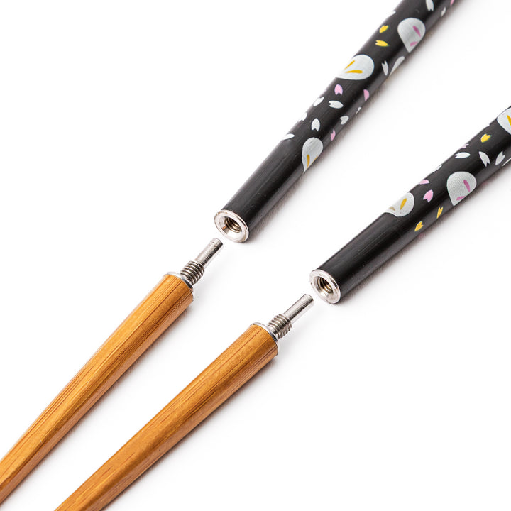 Portable Japanese travel chopsticks detached into two pieces showing the screw in metal joints for easy assembly