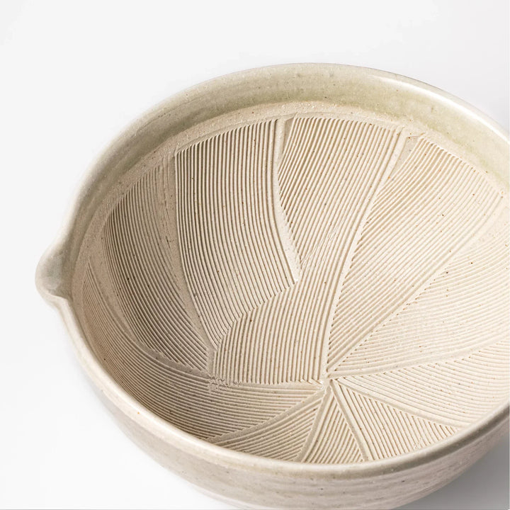 Celadon Japanese suribachi mortar with finely grooved interior and spout for grinding sesame and sauces.