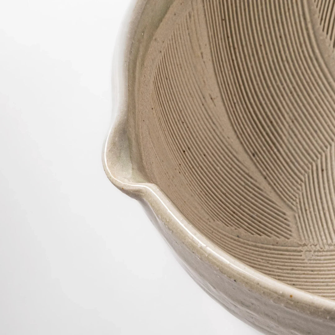 Celadon Japanese suribachi mortar with finely grooved interior and spout for grinding sesame and sauces.