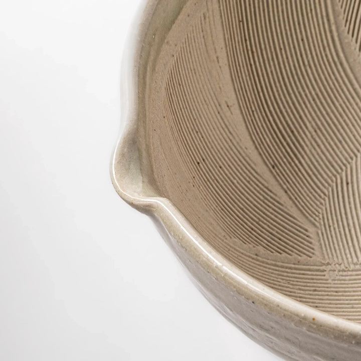 Celadon Japanese suribachi mortar with finely grooved interior and spout for grinding sesame and sauces.
