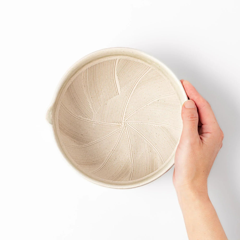 Celadon Japanese suribachi mortar with finely grooved interior and spout for grinding sesame and sauces.