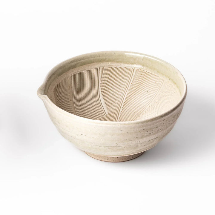 Celadon Japanese suribachi mortar with finely grooved interior and spout for grinding sesame and sauces.