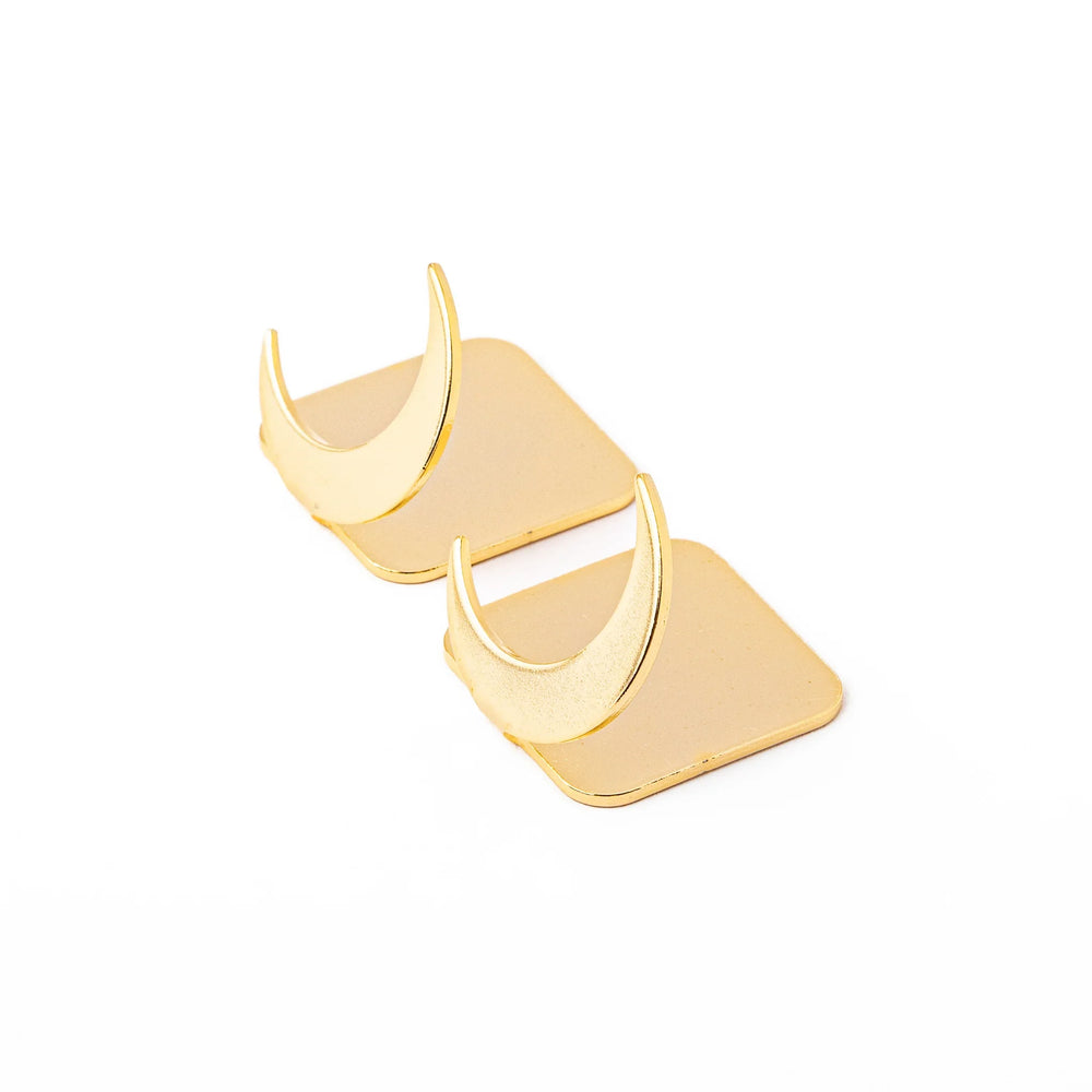 Set of two elegant celestial gold chopstick rests featuring unique crescent moon shapes brass style luxury hashioki