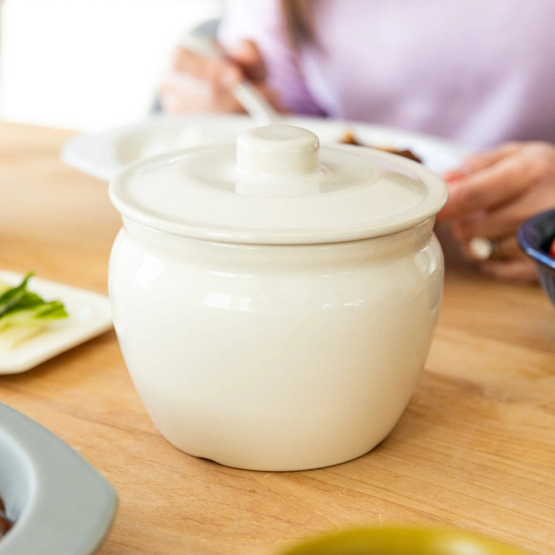 Nami from Just One Cookbook serving meal with ceramic asazuke pickle jar on dining table