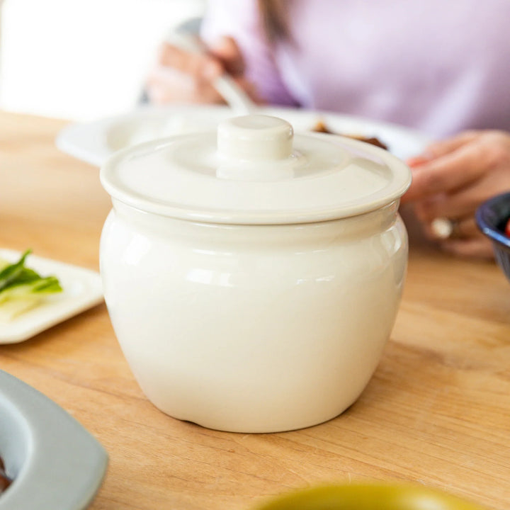 Nami from Just One Cookbook serving meal with ceramic asazuke pickle jar on dining table