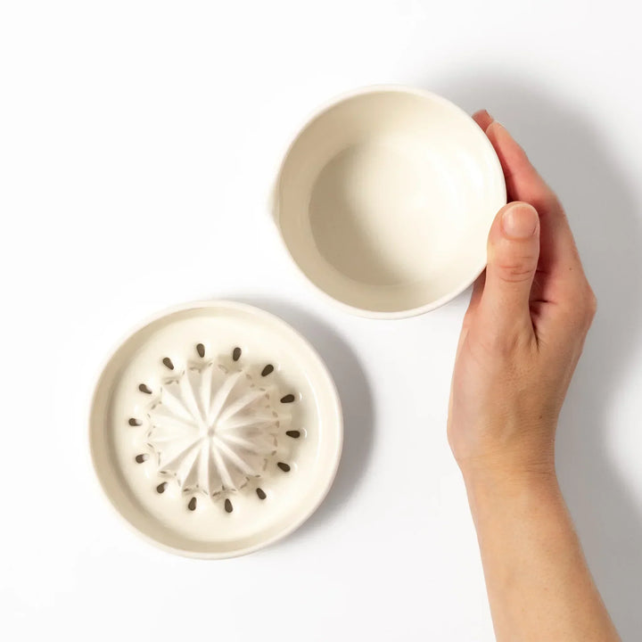 White Japanese ceramic citrus juicer with ridged reamer and strainer for squeezing lemons limes and citrus.