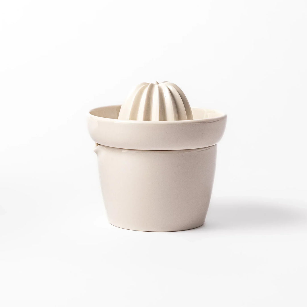 White Japanese ceramic citrus juicer with ridged reamer and strainer for squeezing lemons limes and citrus.