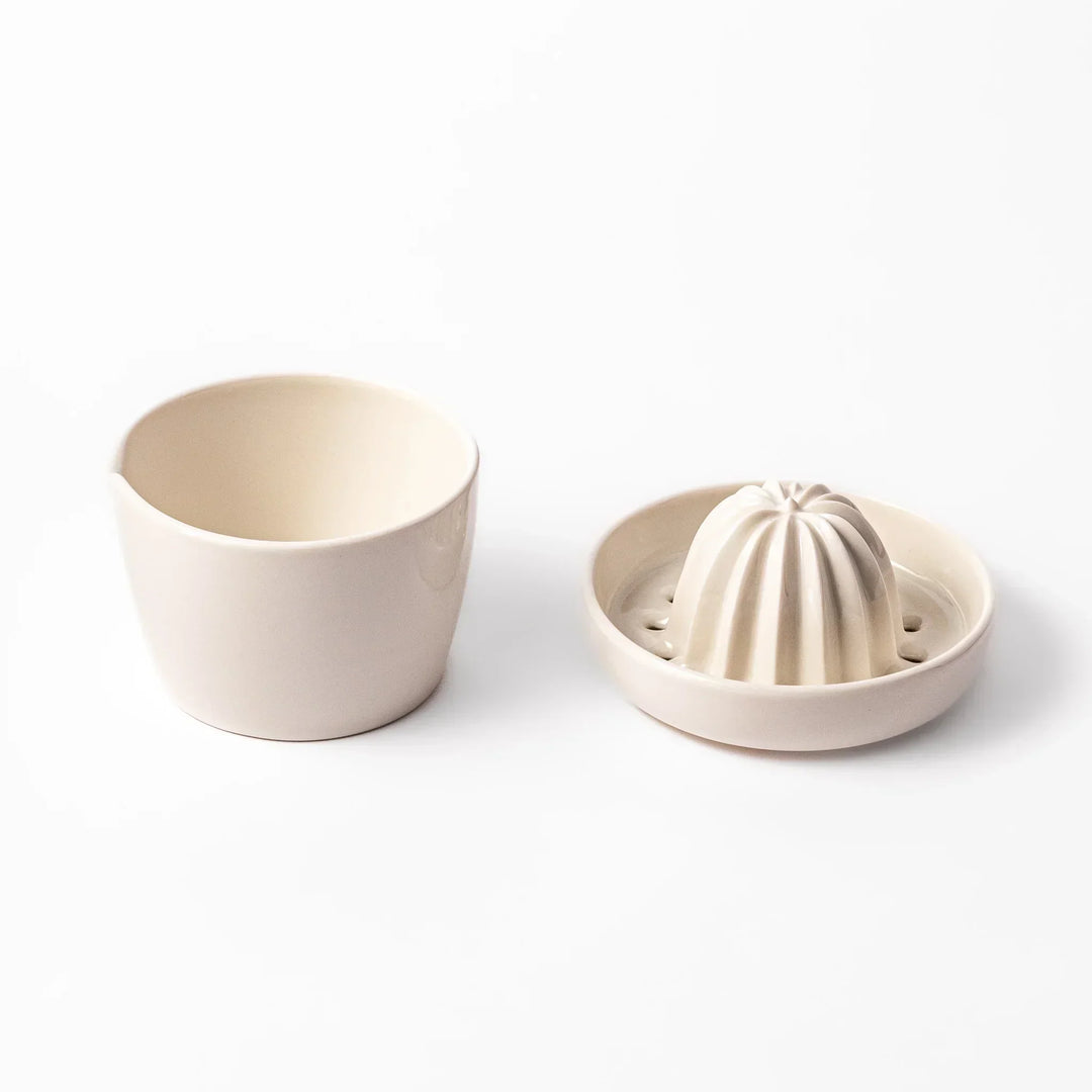 White Japanese ceramic citrus juicer with ridged reamer and strainer for squeezing lemons limes and citrus.