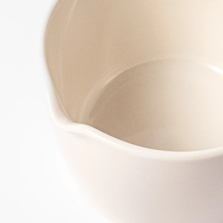 White Japanese ceramic citrus juicer with ridged reamer and strainer for squeezing lemons limes and citrus.