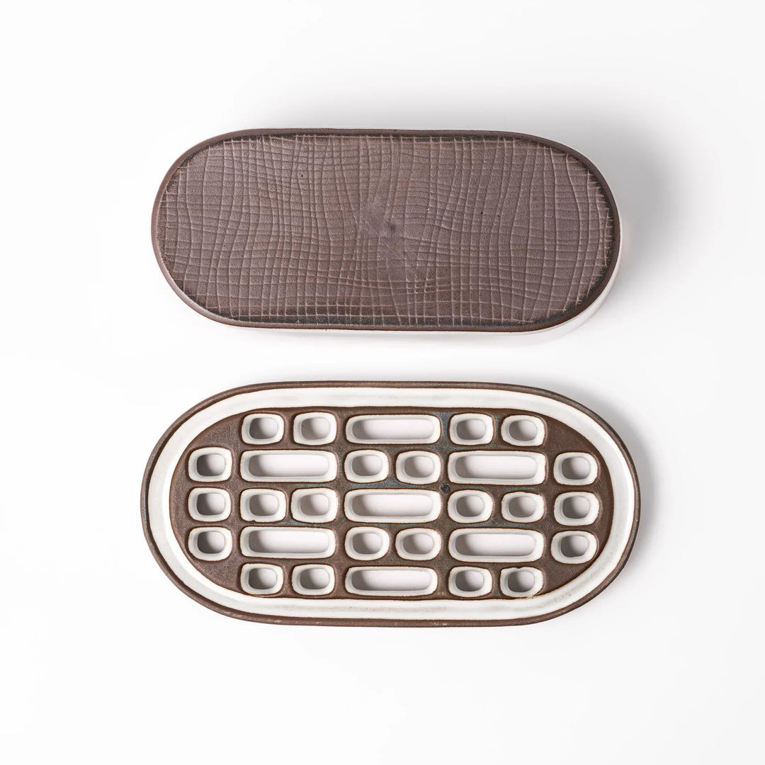 White Japanese ceramic daikon oroshi grater with built in dish and wide holes for grating daikon or ginger.