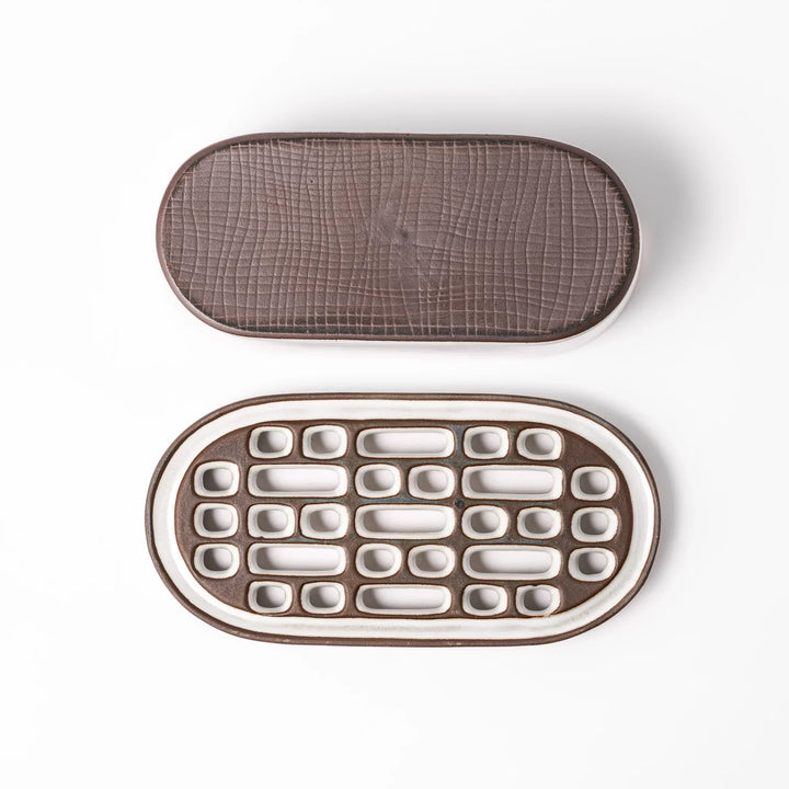 White Japanese ceramic daikon oroshi grater with built in dish and wide holes for grating daikon or ginger.