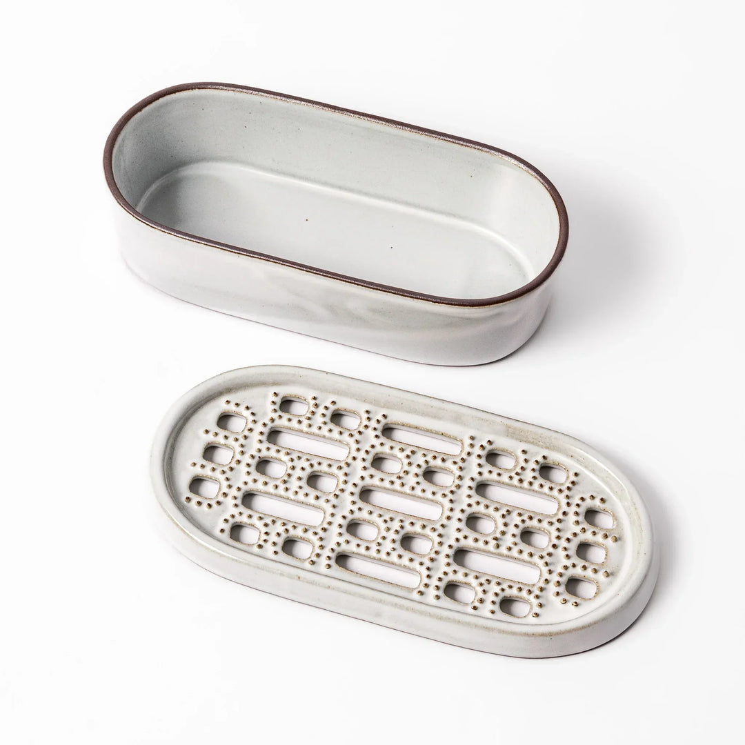 White Japanese ceramic daikon oroshi grater with built in dish and wide holes for grating daikon or ginger.