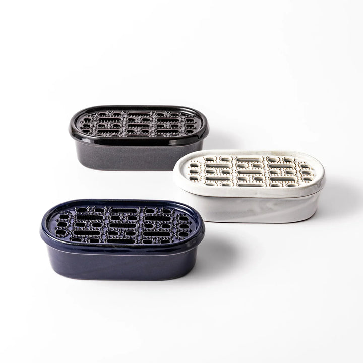 Set of three Japanese ceramic daikon oroshi graters in black white and blue with wide holes for smooth prep.