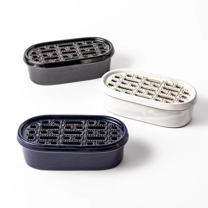 Set of three Japanese ceramic daikon oroshi graters in black white and blue with wide holes for smooth prep.