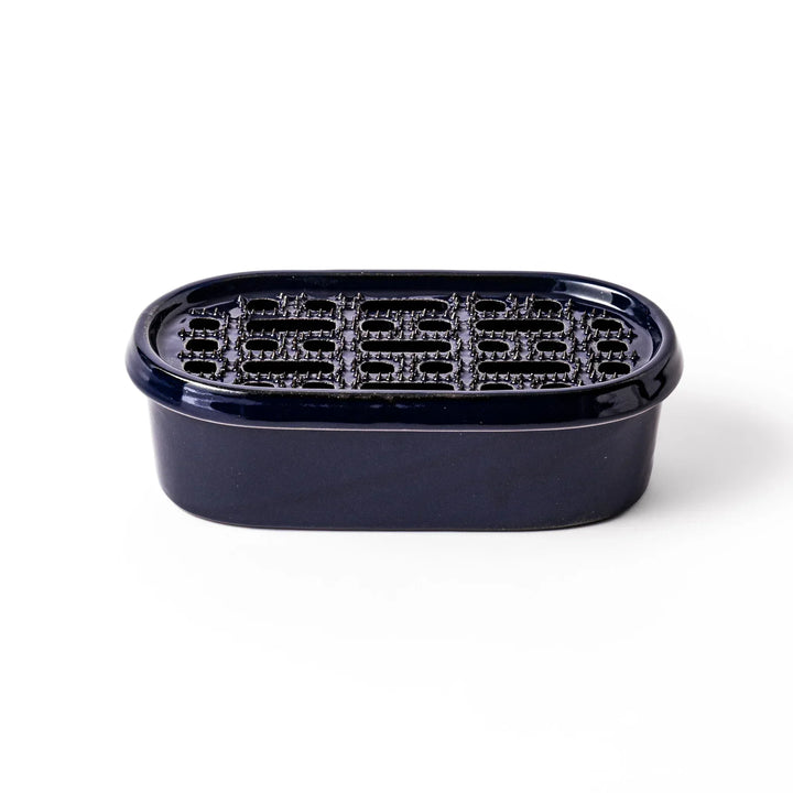 Deep blue Japanese ceramic daikon oroshi grater with built in dish and raised texture for easy grating.