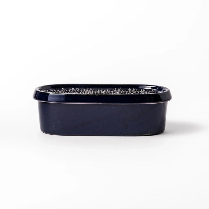 Deep blue Japanese ceramic daikon oroshi grater with built in dish and raised texture for easy grating.