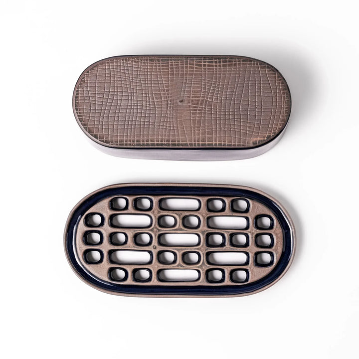 Deep blue Japanese ceramic daikon oroshi grater with built in dish and raised texture for easy grating.