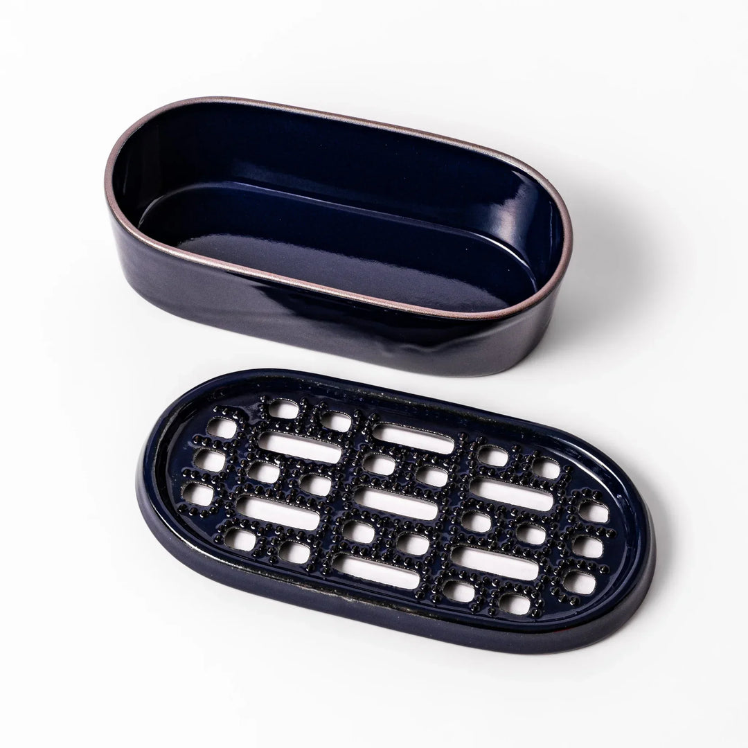 Deep blue Japanese ceramic daikon oroshi grater with built in dish and raised texture for easy grating.