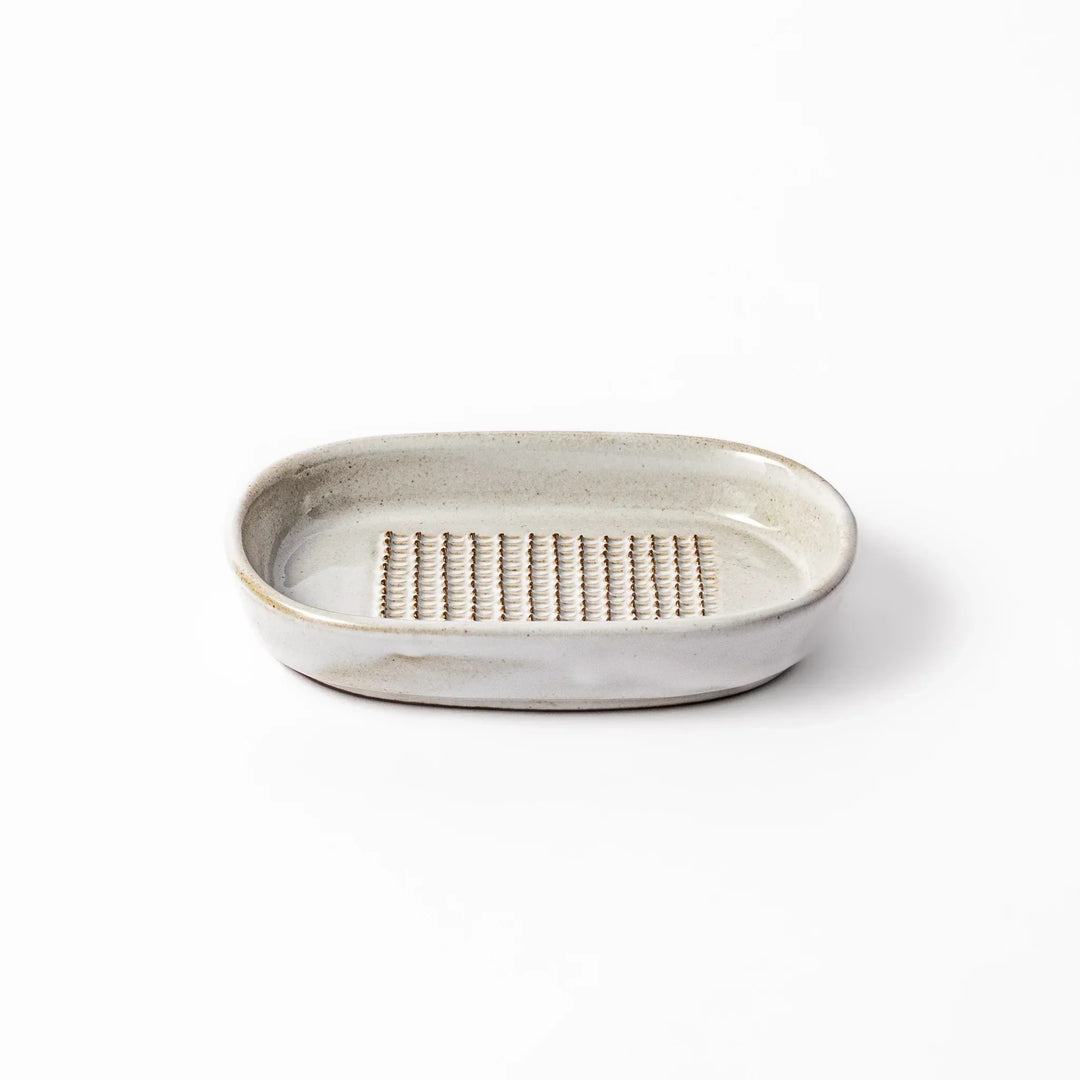 White Japanese ceramic ginger grater dish with natural glaze and raised teeth for grating ginger or garlic.