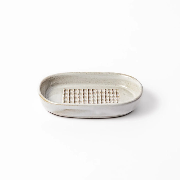 White Japanese ceramic ginger grater dish with natural glaze and raised teeth for grating ginger or garlic.