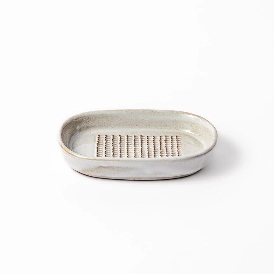 White Japanese ceramic ginger grater dish with natural glaze and raised teeth for grating ginger or garlic.