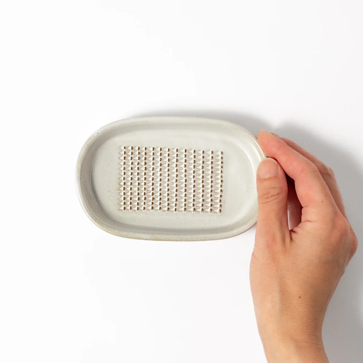 White Japanese ceramic ginger grater dish with natural glaze and raised teeth for grating ginger or garlic.