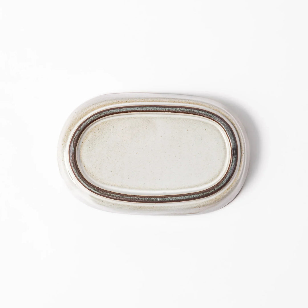 White Japanese ceramic ginger grater dish with natural glaze and raised teeth for grating ginger or garlic.