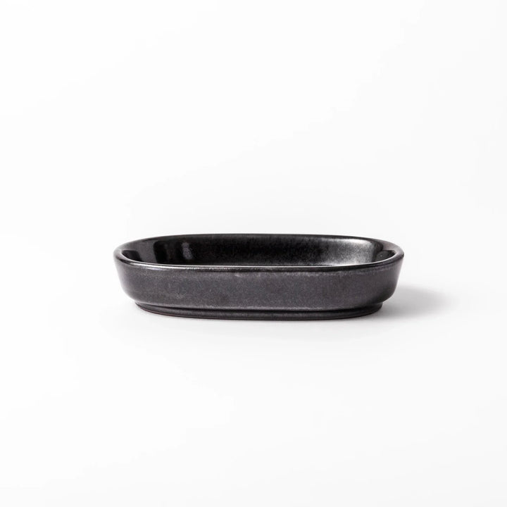 Black ceramic grater dish with raised teeth and shallow oval base, perfect for finely grating ginger, garlic, or daikon.