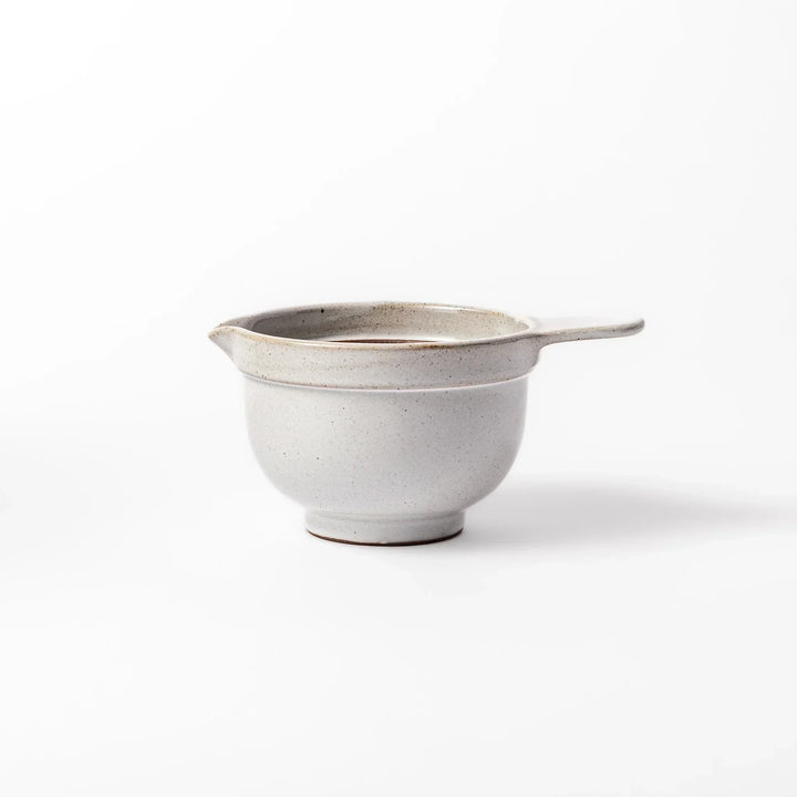 White Japanese ceramic natto suribachi bowl with brown textured interior and side handle for mixing or grinding.