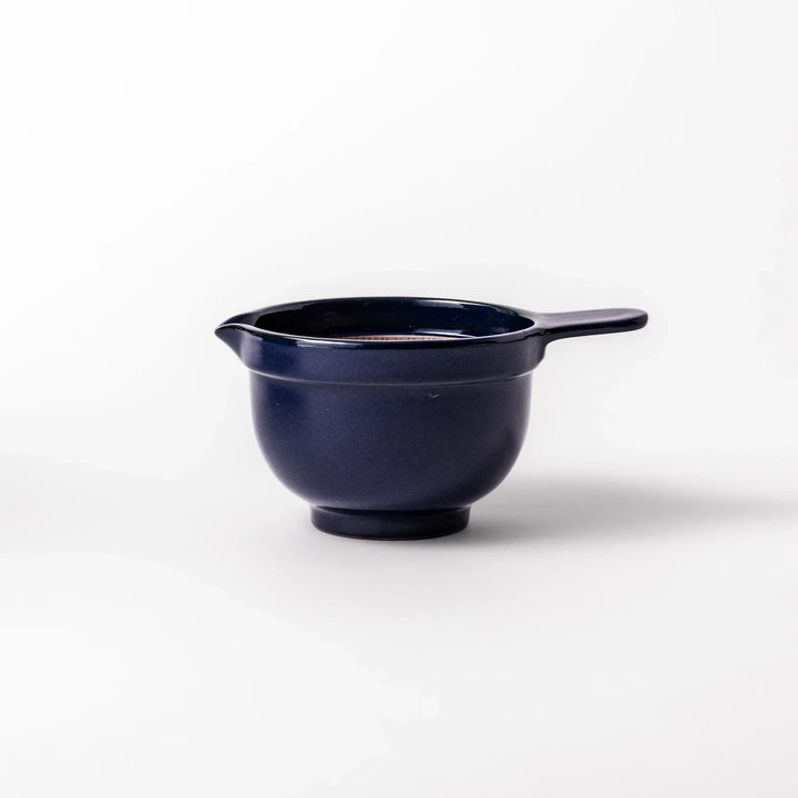 Deep blue Japanese ceramic natto suribachi bowl with ridged brown interior and handle for mixing or grinding.