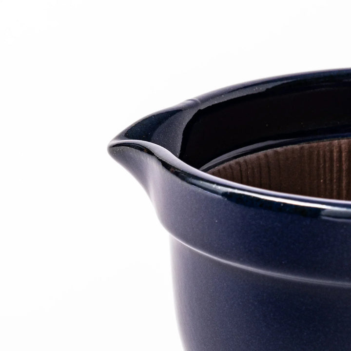 Deep blue Japanese ceramic natto suribachi bowl with ridged brown interior and handle for mixing or grinding.