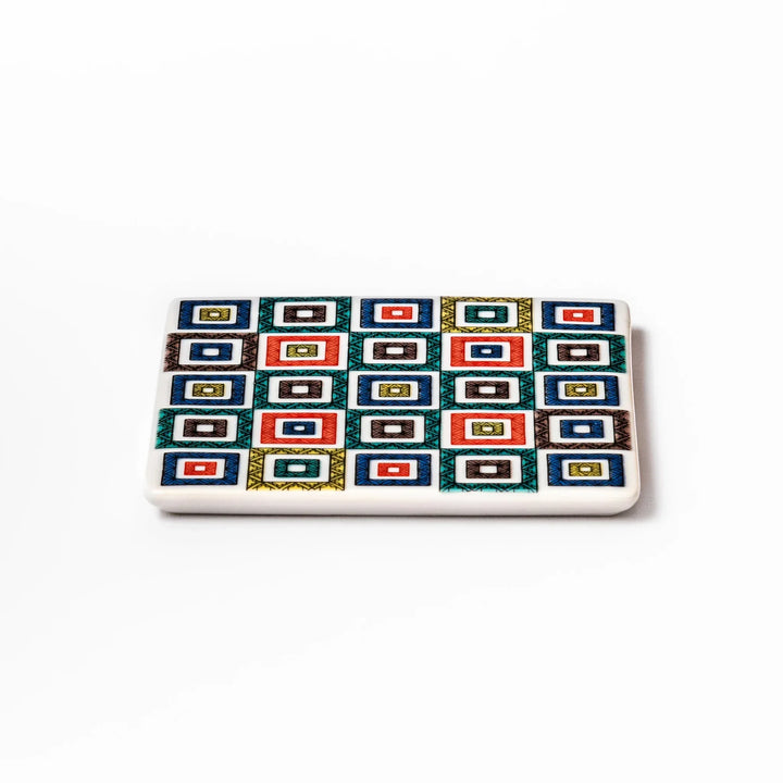Square Japanese ceramic coaster with colorful cobblestone mosaic pattern in red blue green yellow and black.