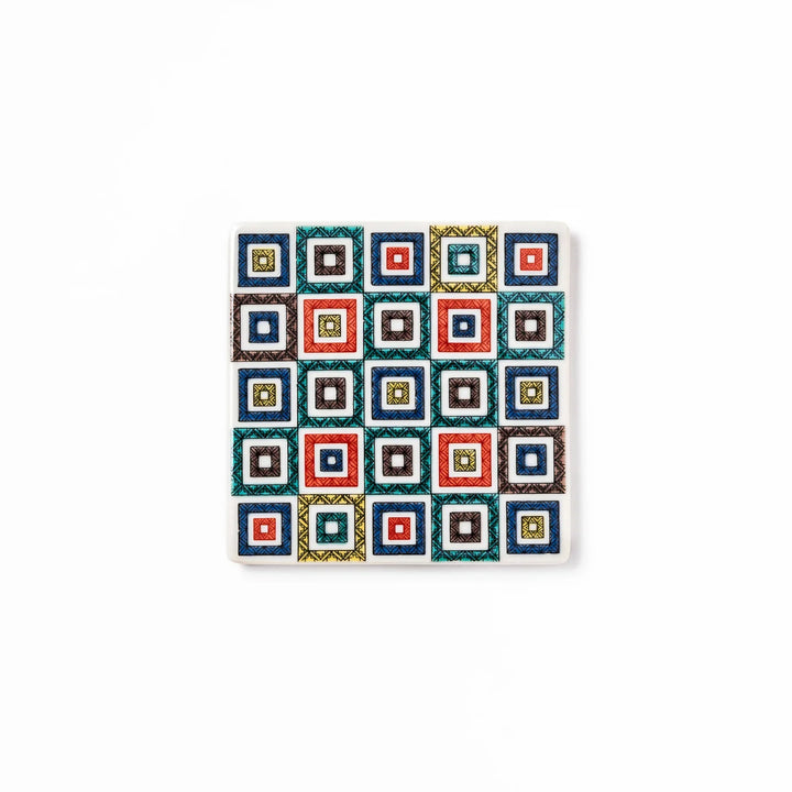Square Japanese ceramic coaster with colorful cobblestone mosaic pattern in red blue green yellow and black.