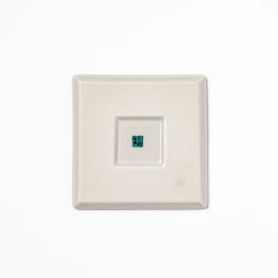 Square Japanese ceramic coaster with colorful cobblestone mosaic pattern in red blue green yellow and black.