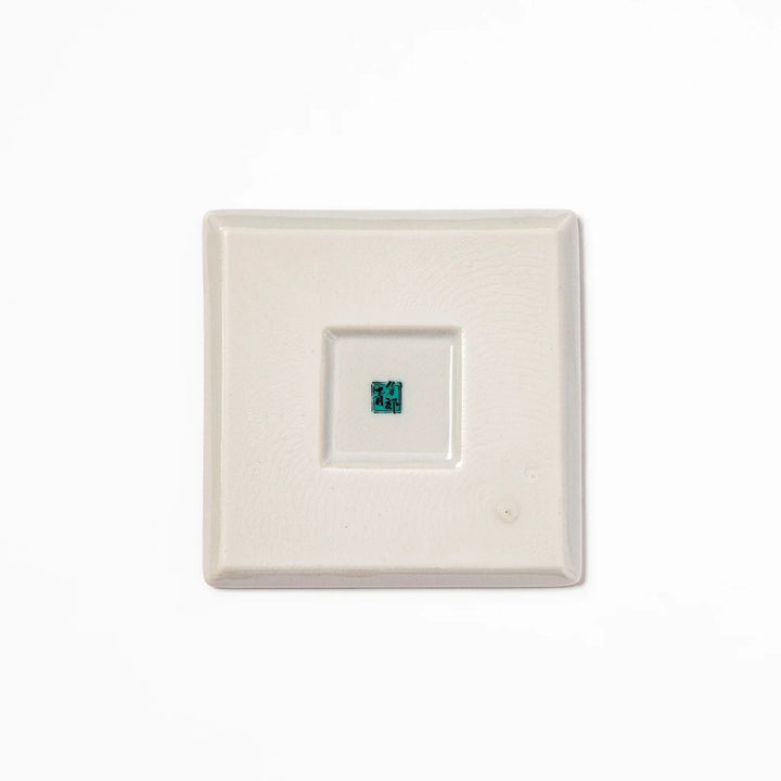 Square Japanese ceramic coaster with colorful cobblestone mosaic pattern in red blue green yellow and black.