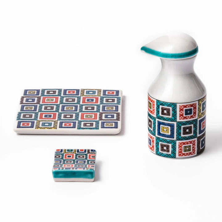 Japanese ceramic tableware set with colorful cobblestone mosaic pattern including dispenser coaster and rest.
