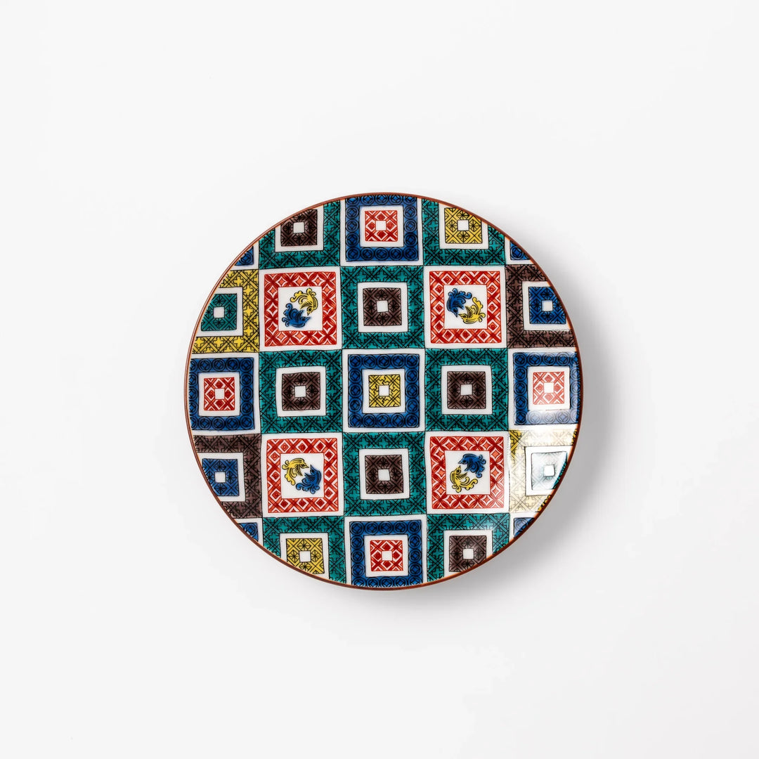 Colorful Japanese porcelain dessert plate with geometric mosaic squares in red green yellow blue and black.